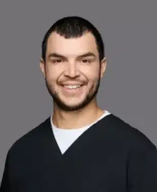 Albert the dentist at Aurora Dental Group smiling in a professional headshot