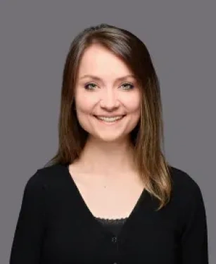 Megan the dental administrator and registered dental assistant at Aurora Dental Group smiling in a professional headshot