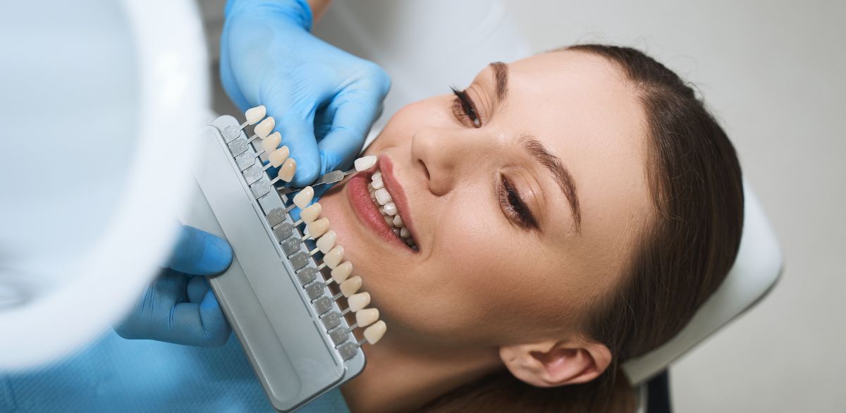dentist matching veneer shade to patients teeth during Christmas in Grants Pass