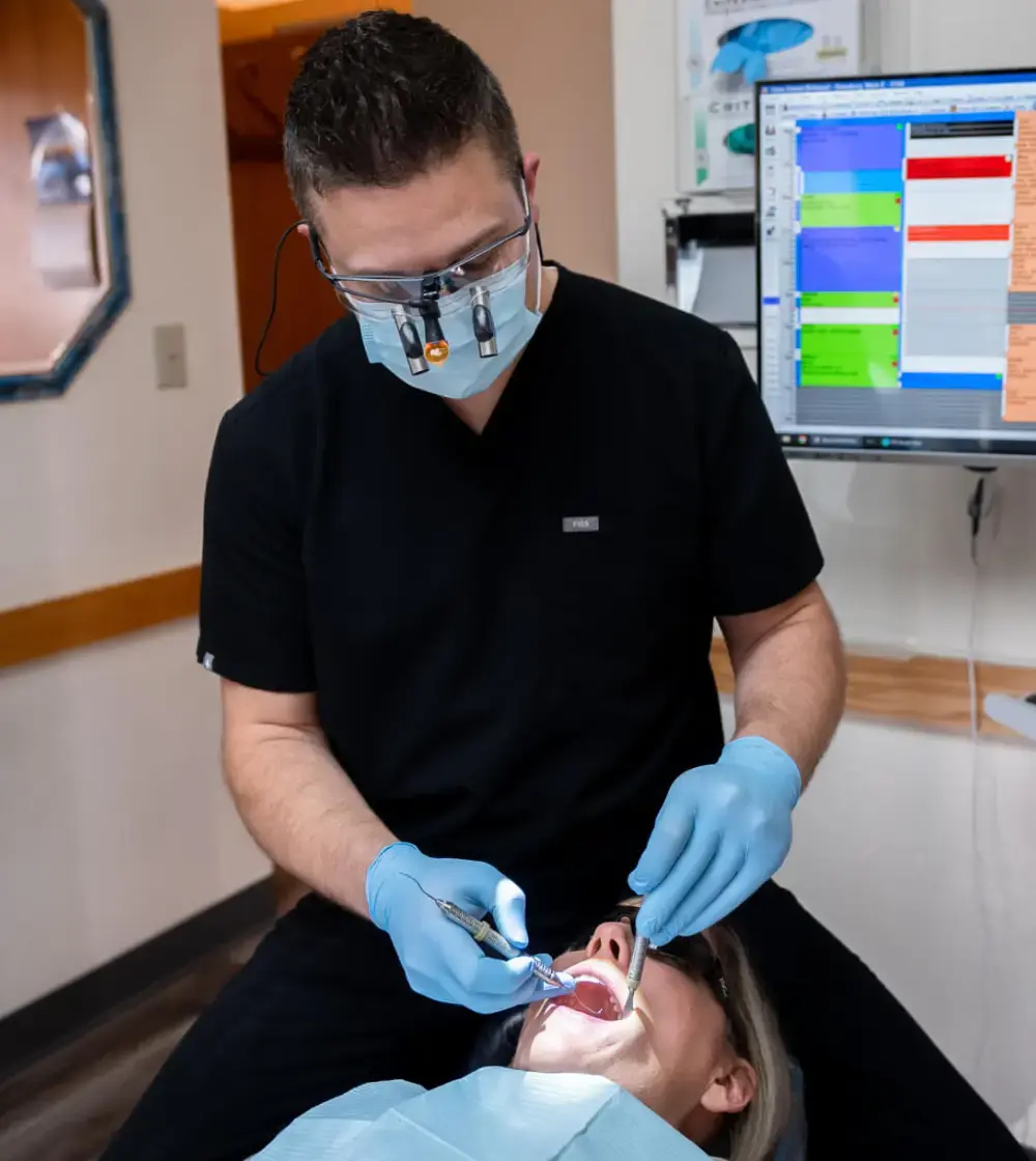 Dentist performing a dental procedure on a patient in Grants Pass, OR.