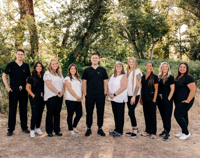 Dental practice team of ten professionals standing together outdoors in Grants Pass, OR.