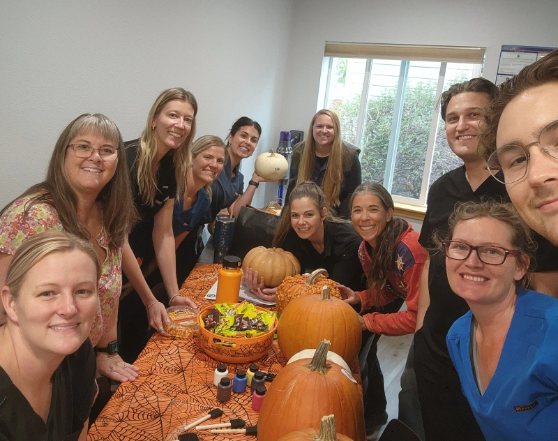 Dental team celebrates at a Grants Pass office pumpkin party with Halloween decorations.