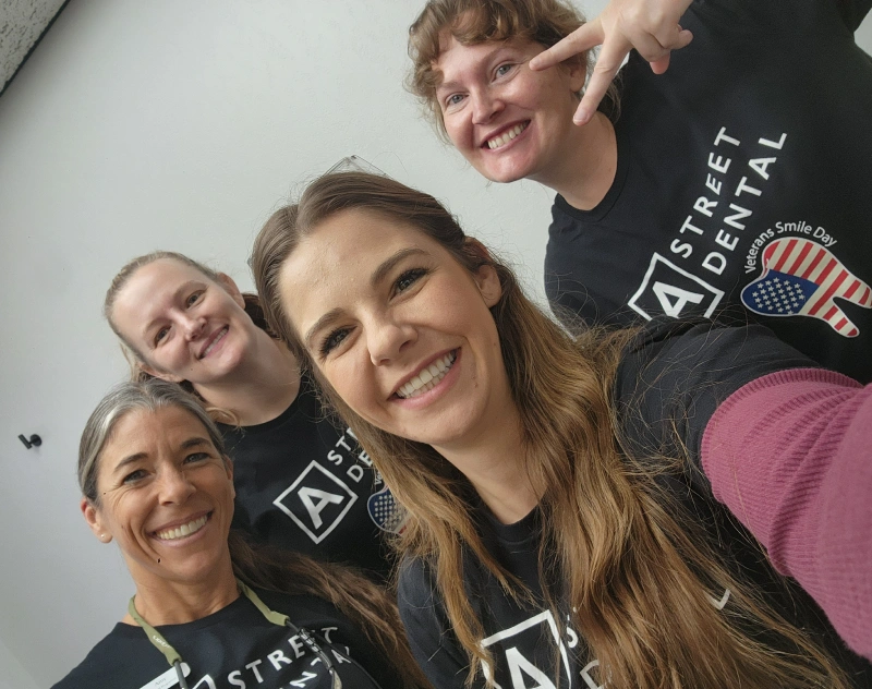 Dental team members smiling together at Grants Pass practice office.