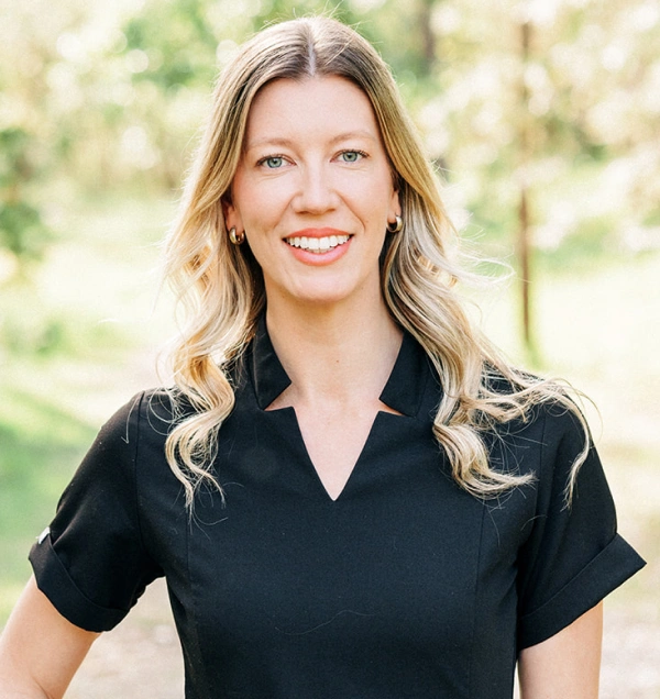 Dr. Caroline Leibrecht, dentist at Grants Pass dental practice, smiling outdoors.