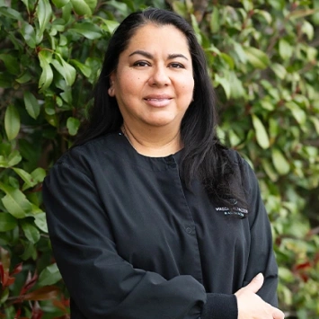 Maria, Registered Dental Assistant at Bedford dental office smiling outdoors
