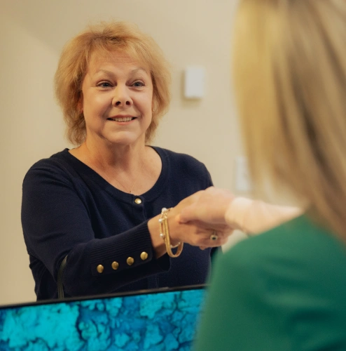 Smiling dental professional greeting a patient in the Newnan, GA dental office.