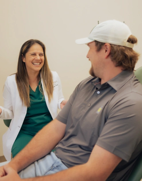 Dentist consulting with patient about sinus grafting procedure in Newnan, GA dental office.