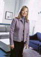 Gina, a dental team member, stands in a professional office setting at the Newnan dental practice.