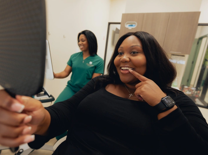 Woman smiling during cosmetic dental consultation at Newnan dental practice.
