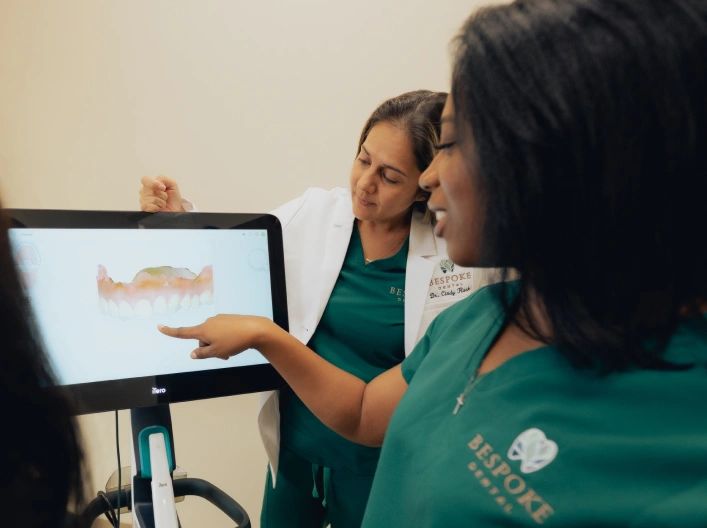 Dentist explaining digital dental scan results to patient during treatment consultation in Newnan.
