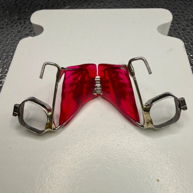 Red orthodontic space maintainer on a dental model