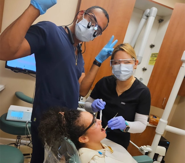 Dental team members demonstrating treatment to a patient in Burbank dental office.