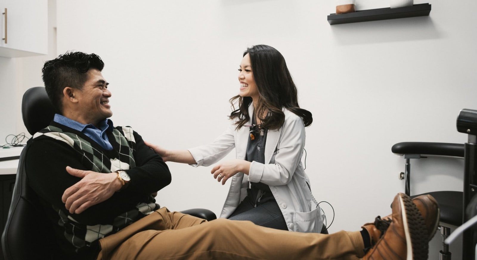 a man and our dentist bella nguyen engaged in a consultation about fixed overdentures in alexandria