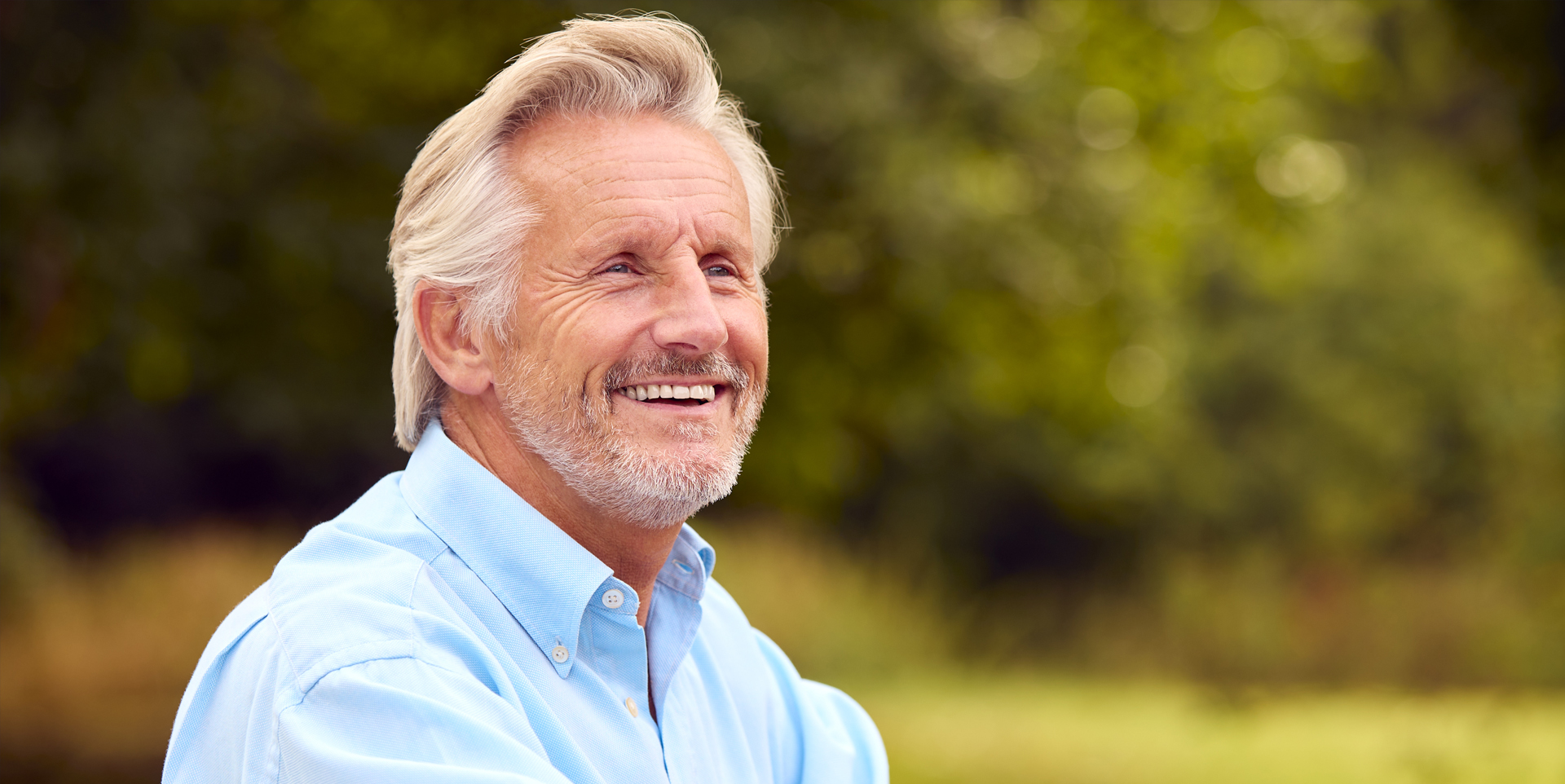Elderly gentleman smiling after restorative dental treatment at Coastal Dental Arts in Peabody, MA