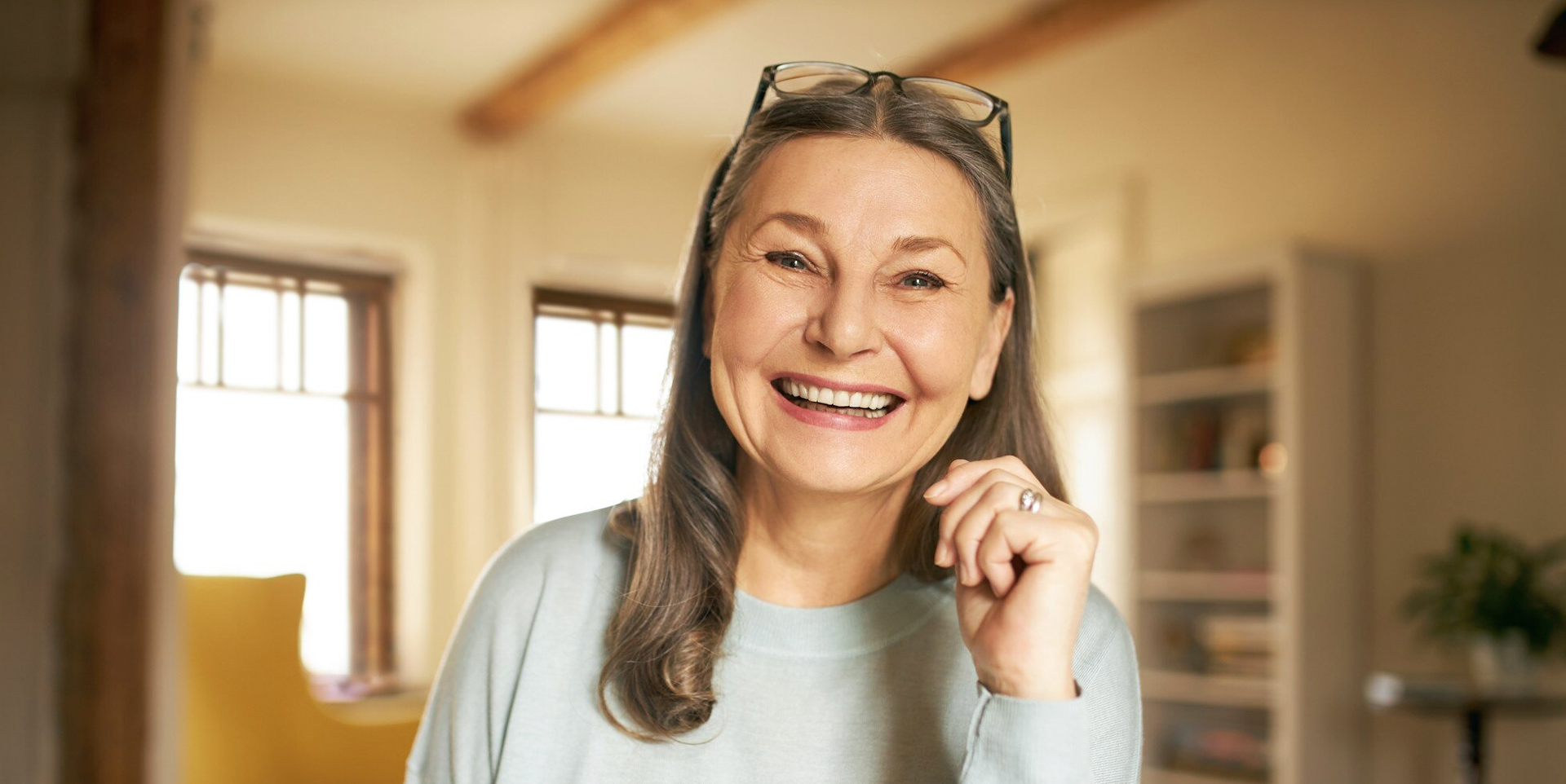 Elderly woman smiling after full mouth implant reconstruction at Coastal Dental Arts in Peabody, MA