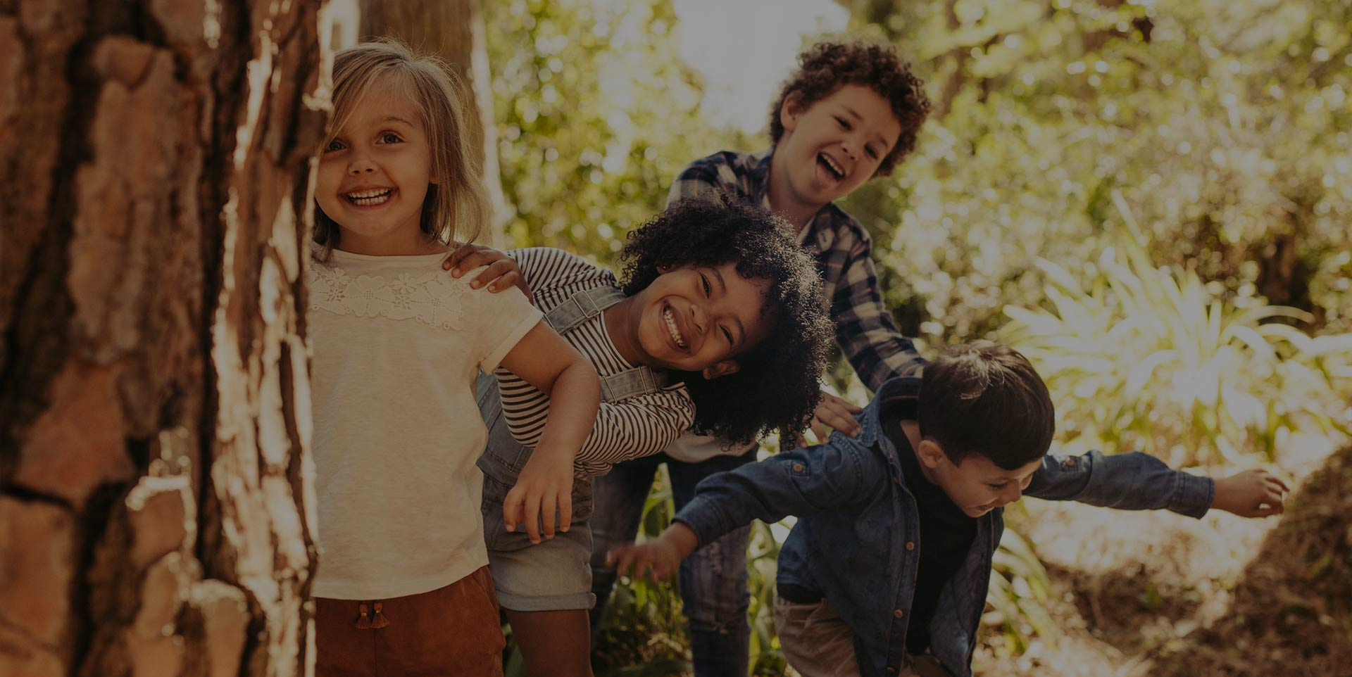 Group of four children smiling after a routine pediatric dental care visit at Coastal Dental Arts in Peabody, MA