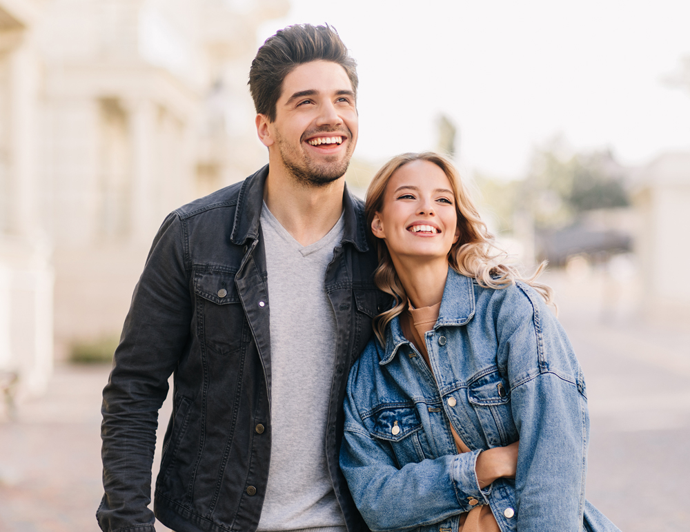 Couple smiling happily after dental bridge treatment at Coastal Dental Arts in Peabody, MA