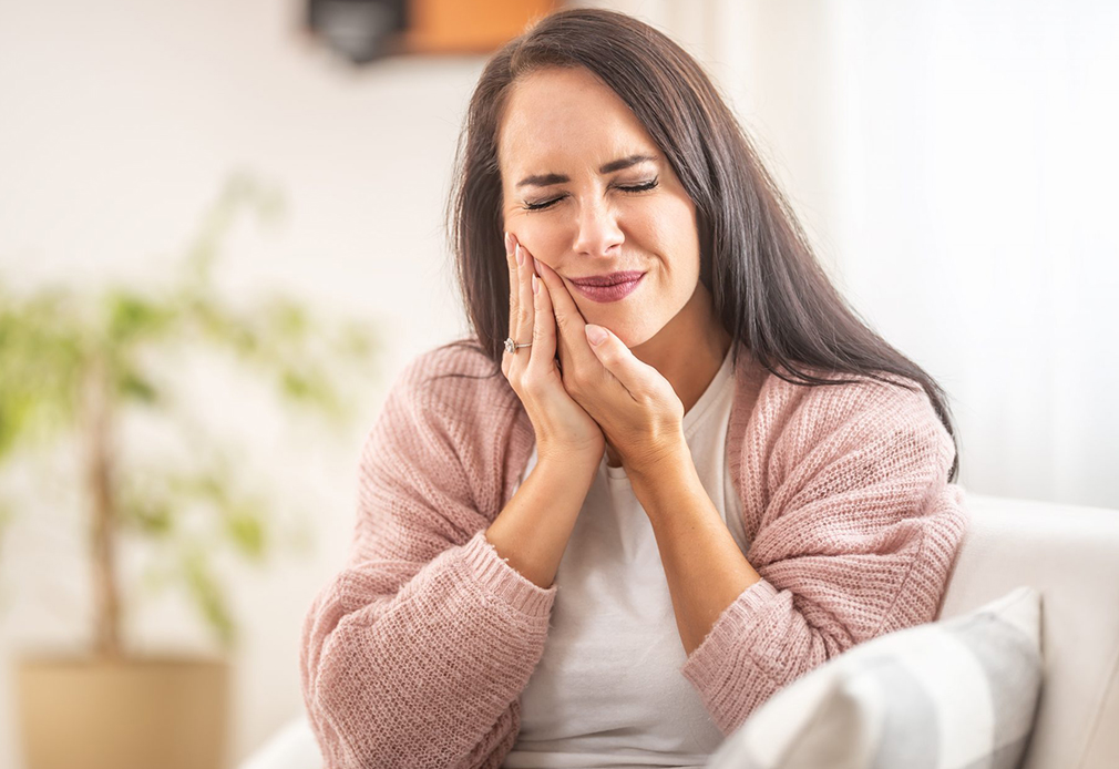 Woman with severe tooth pain visiting Coastal Dental Arts in Peabody, MA for emergency dental care