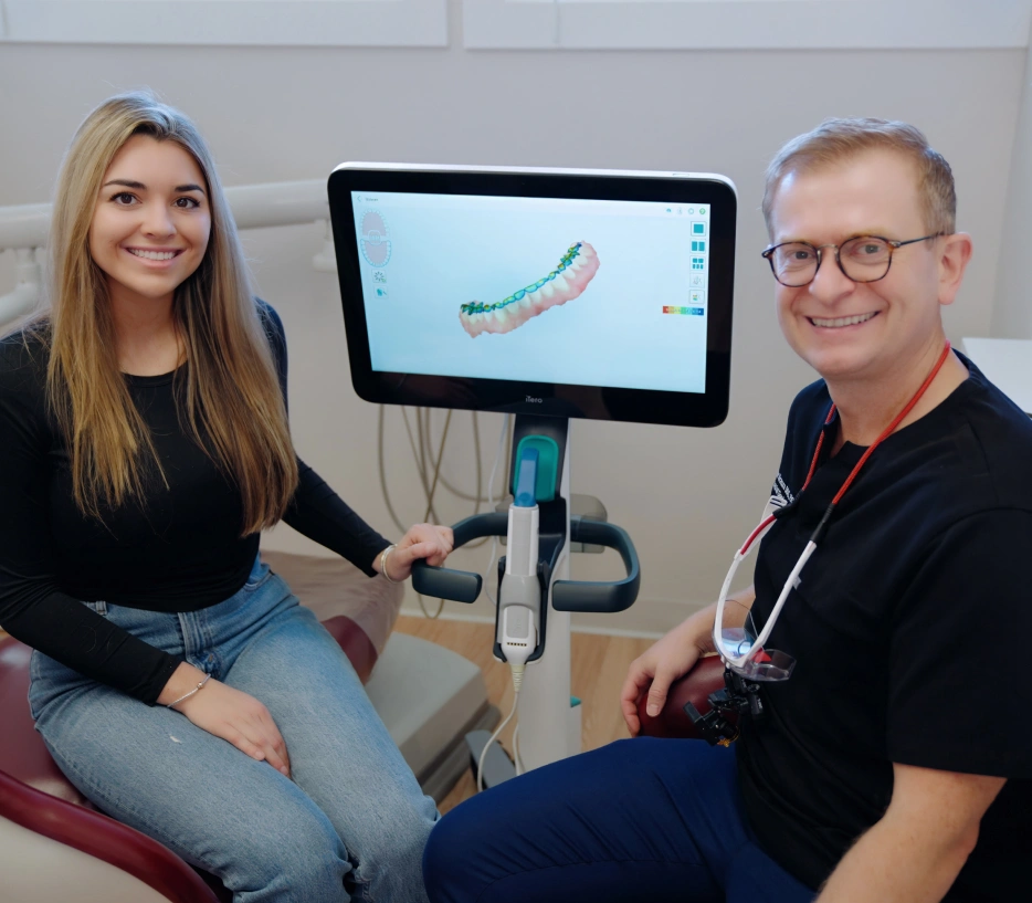 Dentist in Peabody Dr. Peter Brzoza, DDS in front of dental 3D imaging machine