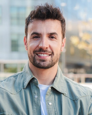 Smiling man showcasing a healthy, bright smile after cosmetic dental treatment