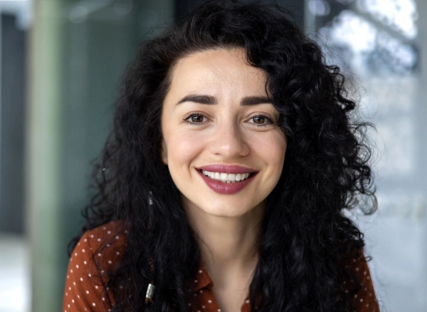 Smiling woman with a healthy smile after replacing missing teeth