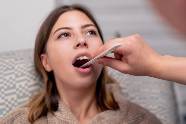 Dentist performing an oral cancer screening during a routine dental exam