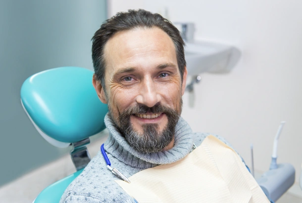 Smiling patient after a successful oral surgery procedure
