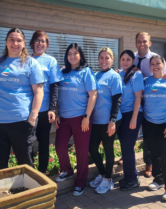 Clear Sky Dental Care team members posing together outdoors in matching blue shirts.