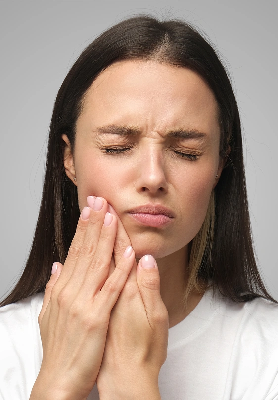Woman experiencing dental pain from a toothache