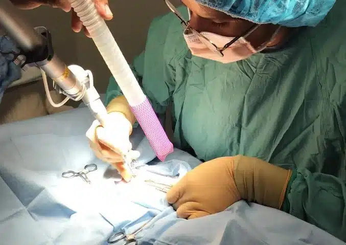 Close-up of veterinary surgeon using laser during an operation