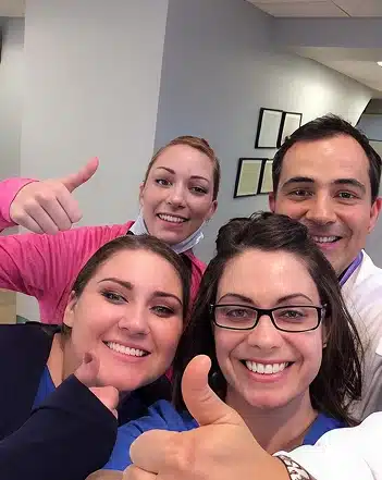 Dr. Cosmo Haralambidis posing with team members inside Cranston Orthodontics