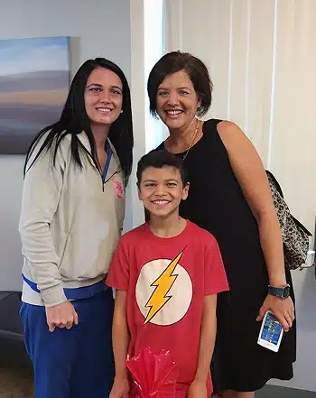 Mother and young son smiling with a dental professional