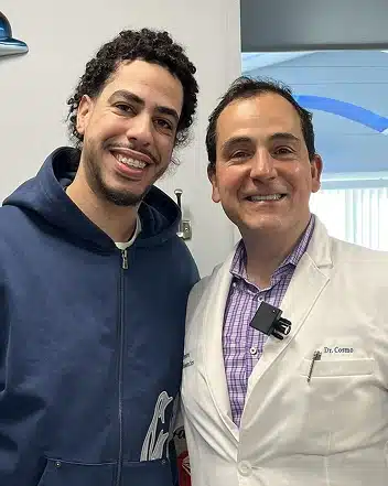 Dr. Cosmo Haralambidis standing with a patient at Cranston Orthodontics