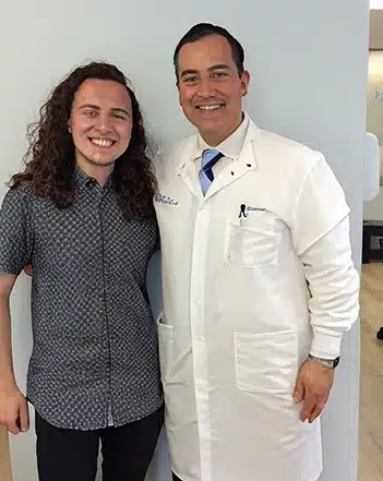 Dr. Cosmo Haralambidis standing with a patient at Cranston Orthodontics