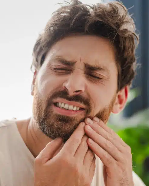 Man experiencing tooth pain and jaw discomfort