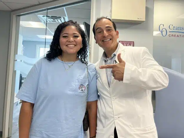 Dr. Cosmo Haralambidis standing with a patient at Cranston Orthodontics