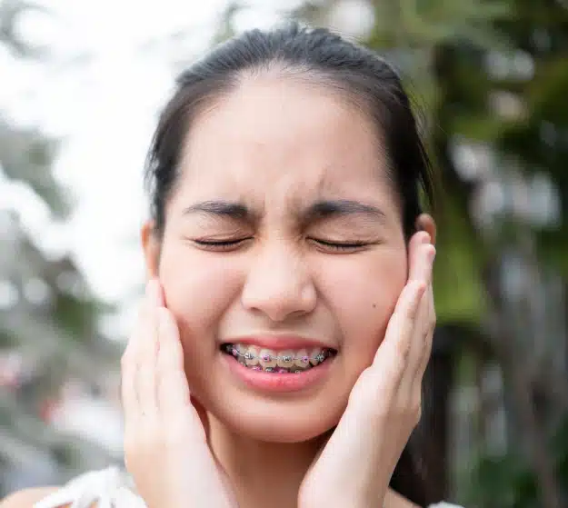 Young patient experiencing tooth pain and dental discomfort