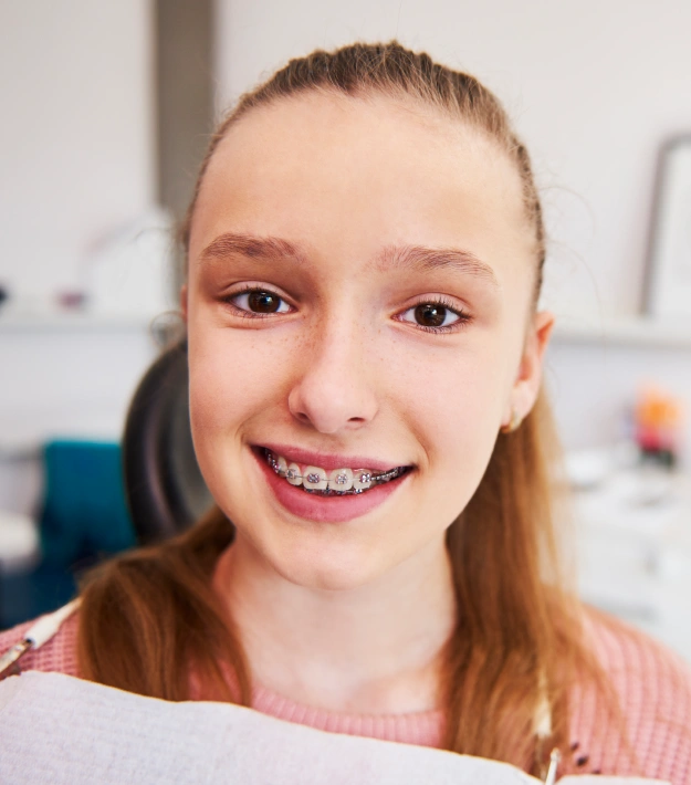 Teenage patient smiling with braces during orthodontic treatment