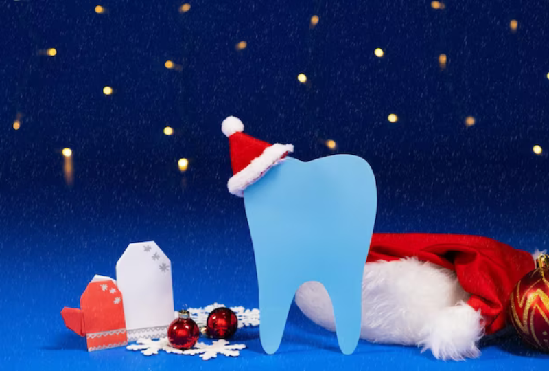 Illustrated blue tooth wearing a Santa hat surrounded by Christmas ornaments on a dark background