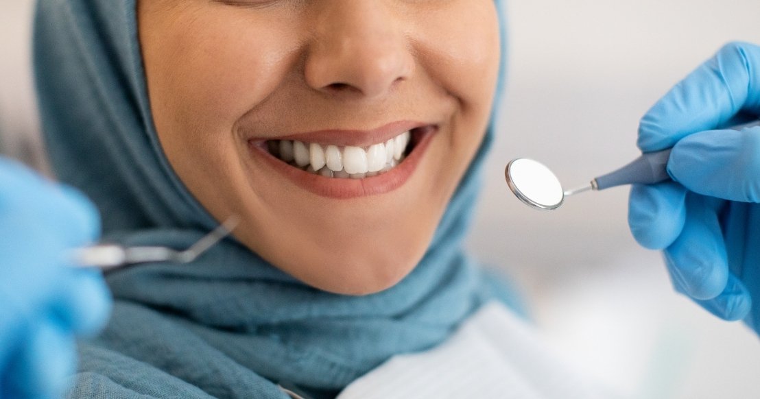 Close up of a woman smiling showing straight white teeth