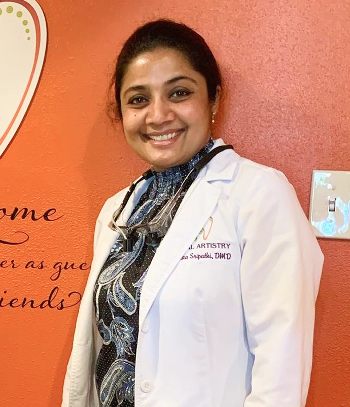 Portrait of Dr. Radhika Srikrishnan Iyer in a white coat smiling in the office