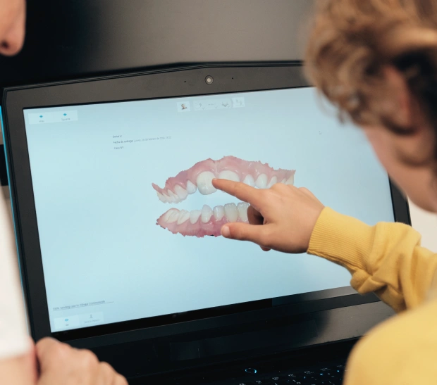 Person touching a digital tablet screen in a dental office setting