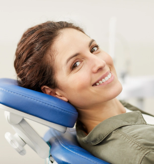 Young woman smiling while reclining in a dental chair