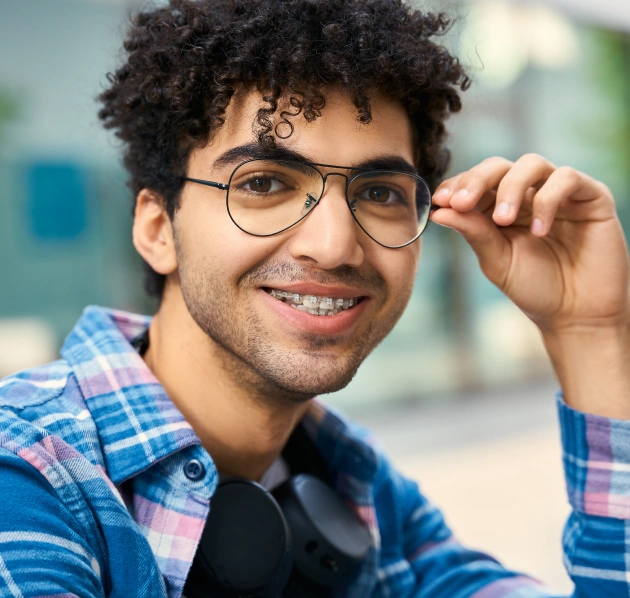 Young man with glasses smiling