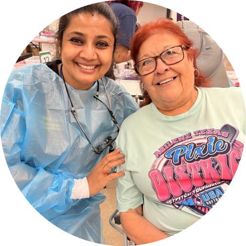 Dental Artistry Irving staff member posing with a smiling patient in the office