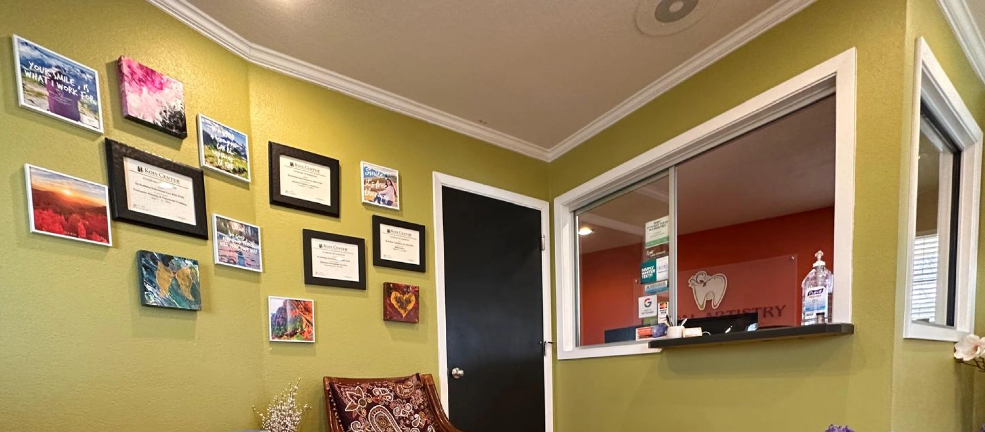 Dental Artistry Irving office hallway with wooden door and warm wall decor