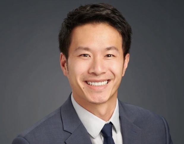Professional headshot of Dr. David Wong smiling in a suit and tie