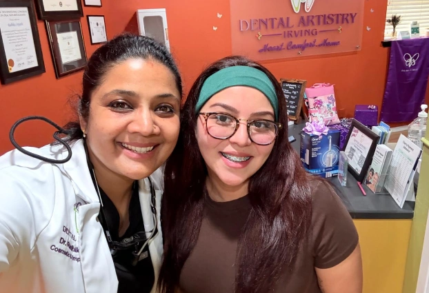 Dr. Radhika Srikrishnan Iyer posing with a smiling patient at Dental Artistry Irving