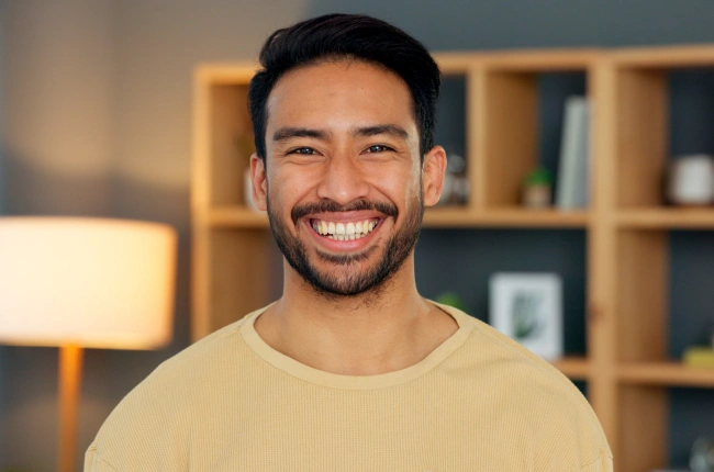 Portrait of a smiling young man in a casual setting indoors