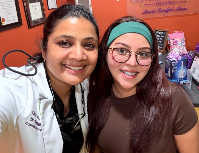 Dr. Radhika Srikrishnan Iyer posing with a smiling patient at Dental Artistry Irving